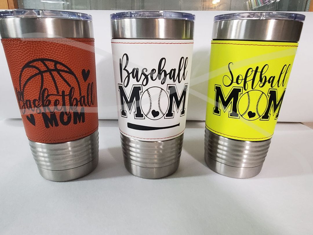 Three tumblers with the words basketball mom and softball mom.